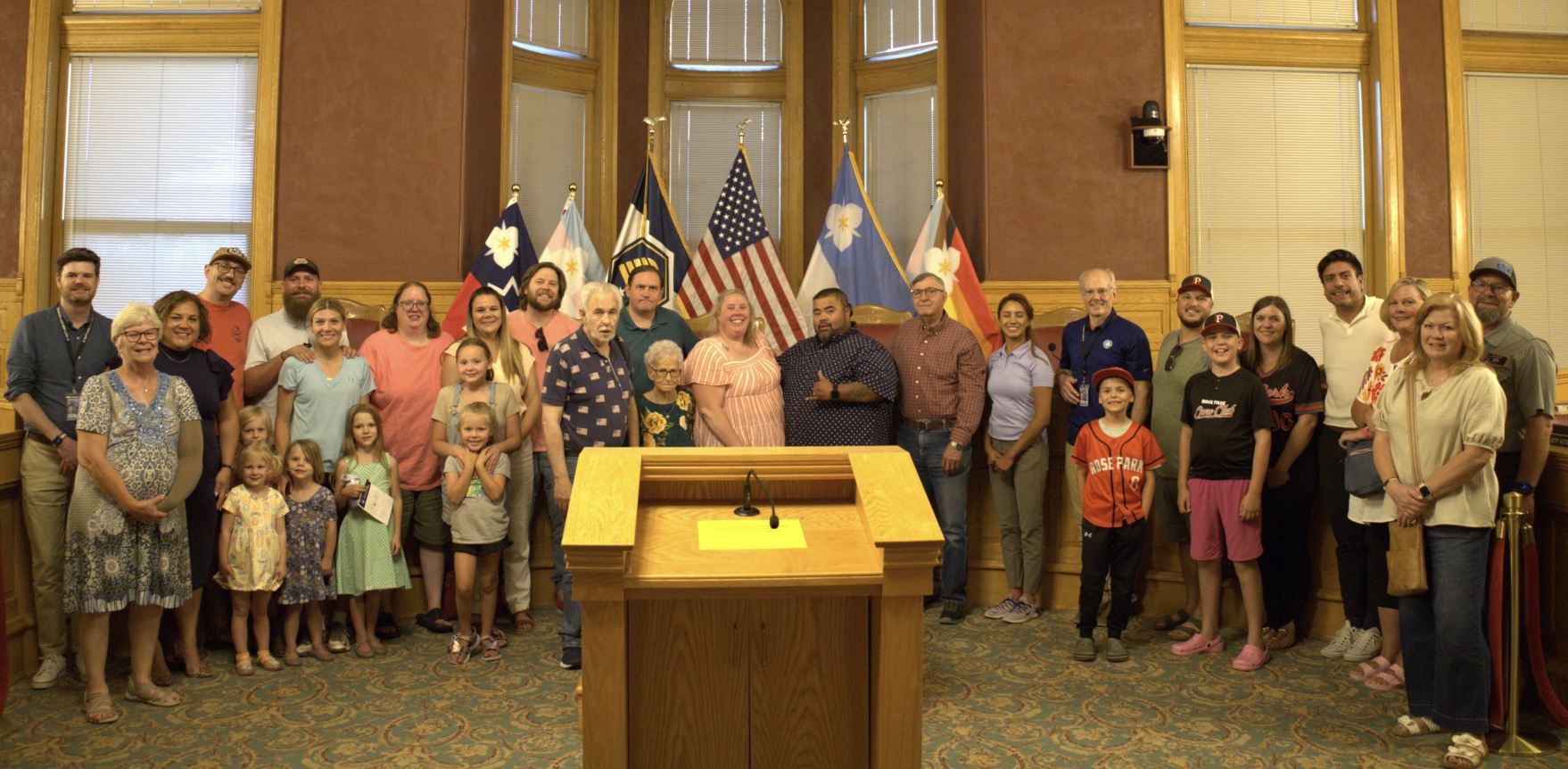 Members of the Salt Lake City Council pose for a photo with the family of Neil Draper and Rose Park Baseball leaders on Tuesday. The city renamed an iconic Rose Park ballpark after Draper.