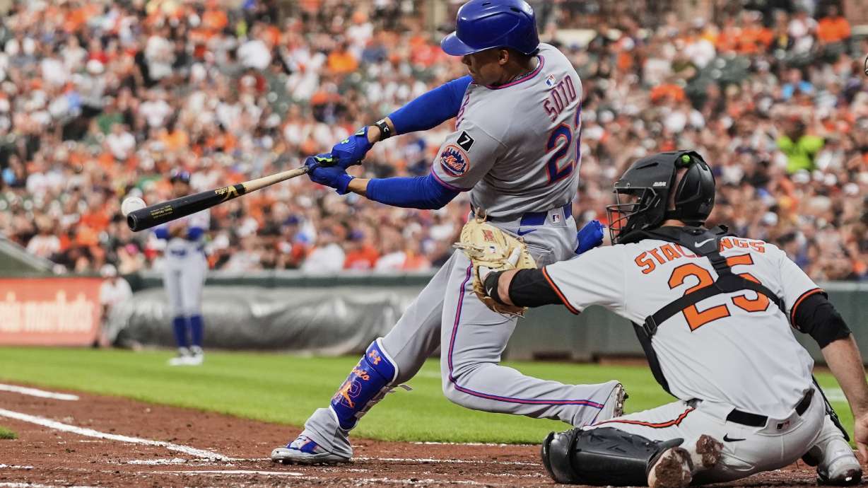 New York Mets' Juan Soto, left, hits a single during the fourth inning of a baseball game against the Baltimore Orioles, Tuesday, July 8, 2025, in Baltimore.