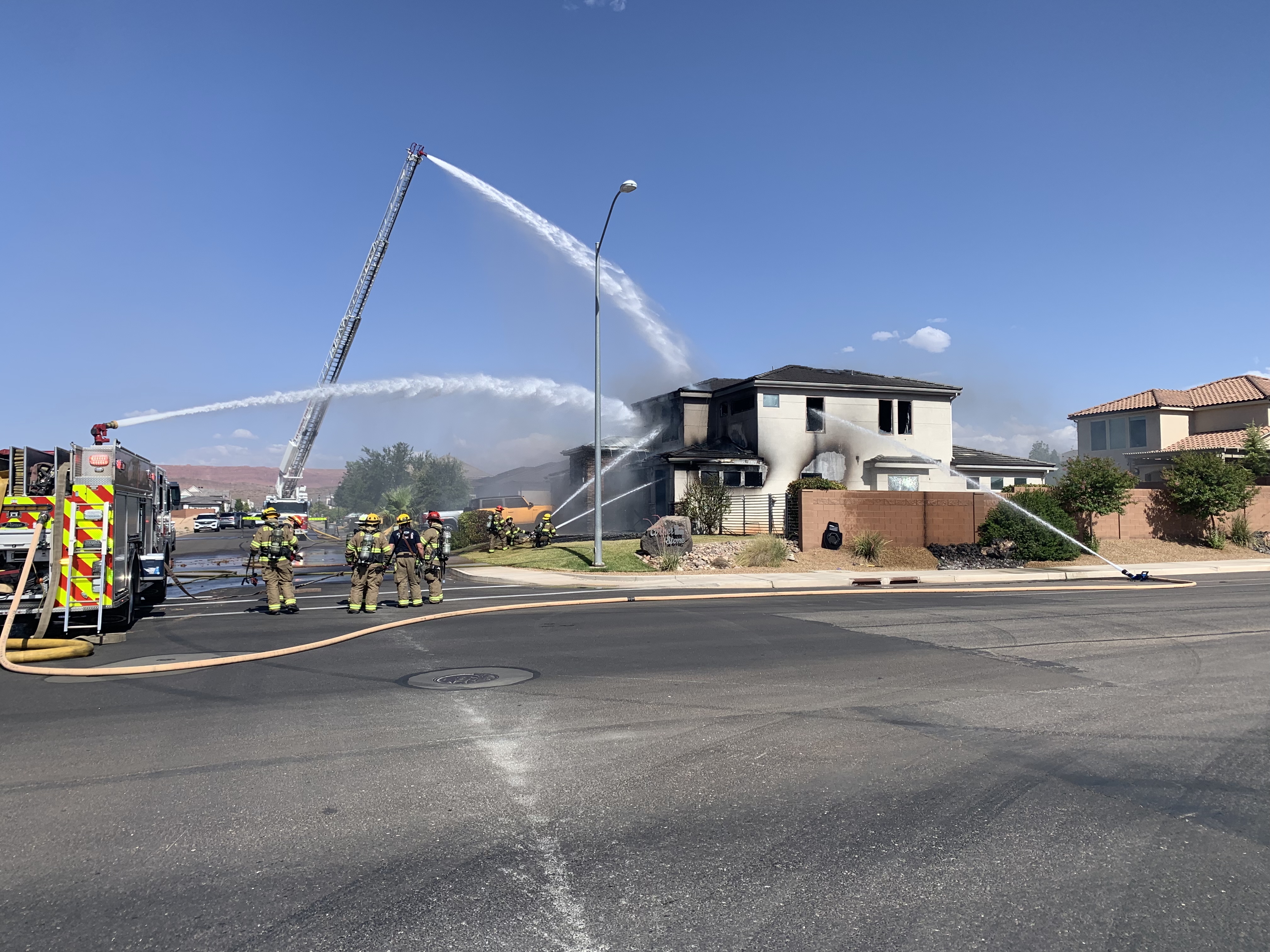 Police say a man barricaded himself inside a house in a St. George neighborhood and exchanged gunfire with law enforcement officers Tuesday, then surrendered to them after the house somehow caught fire.