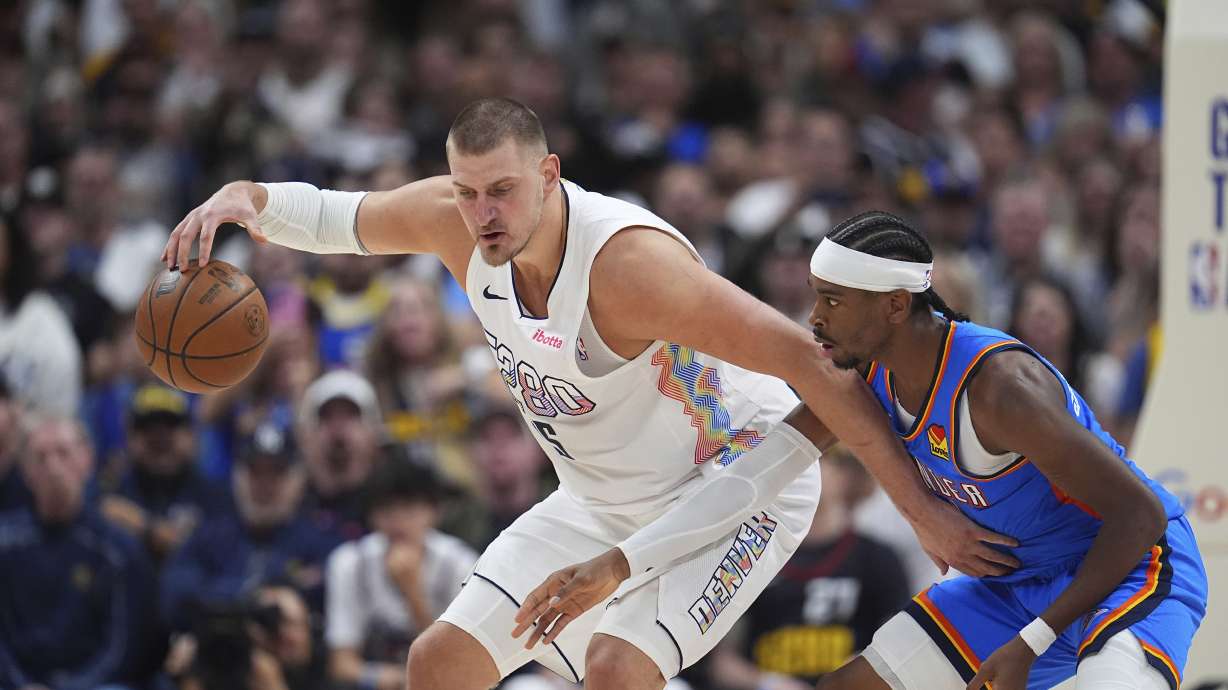 FILE - Denver Nuggets center Nikola Jokic (15) and Oklahoma City Thunder guard Shai Gilgeous-Alexander (2) in the second half of Game 6 in the Western Conference semifinals of the NBA basketball playoffs on May 15, 2025, in Denver.