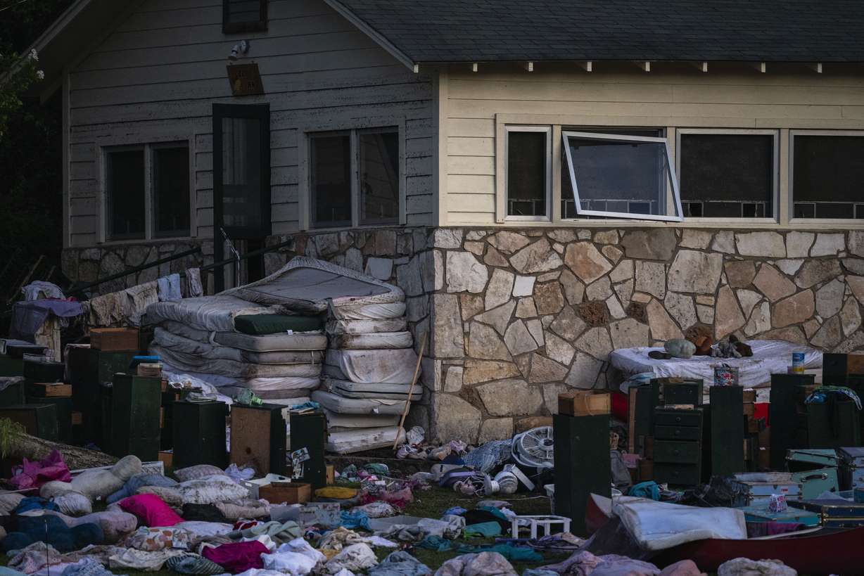Camper's belongings sit outside one of Camp Mystic's cabins near the Guadalupe River, Monday, in Hunt, Texas, after a flash flood swept through the area.