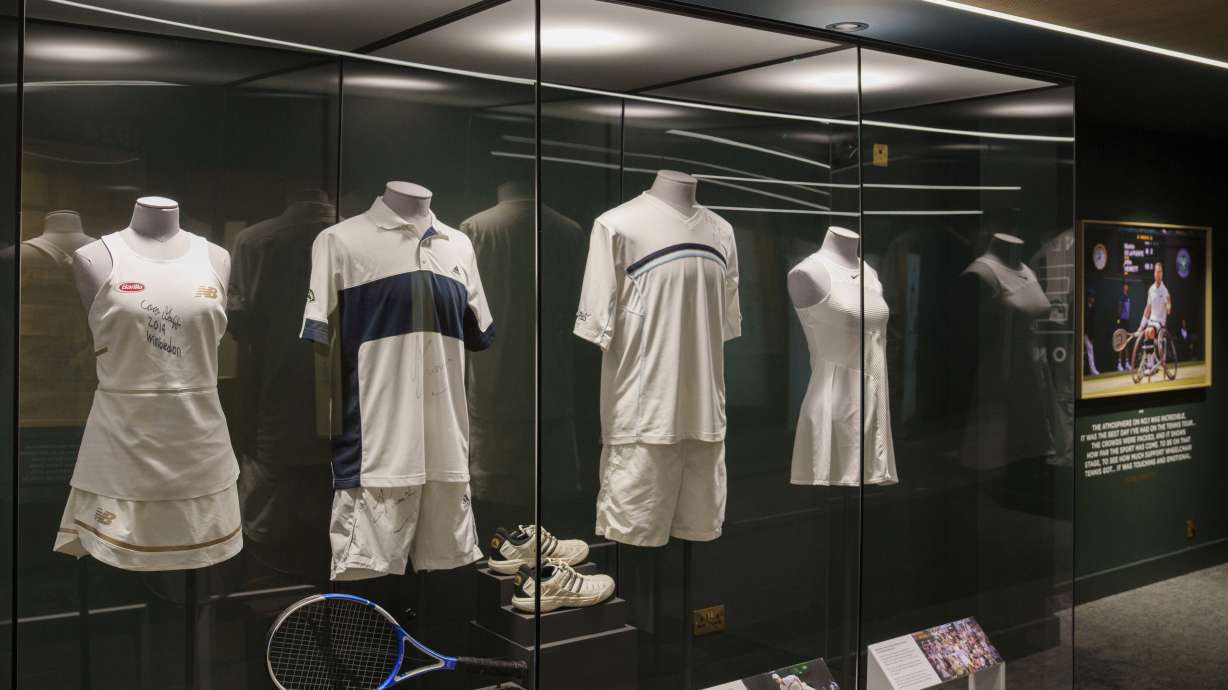 The 2019 dress worn by Coco Gauff, left, can be seen in a display in the No. 1 Court player walk-on entrance at the All England Lawn Tennis Club in Wimbledon, London, Wednesday July 2, 2025.