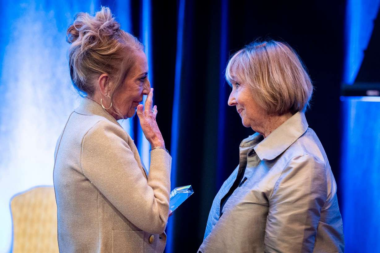 Camie Palmer, left, a kindergarten teacher at The Center for Creativity, Innovation, and Discovery, reacts beside Kathi Garff, board chair of the Ken Garff Automotive Group, after Palmer received the distinguished educator lifetime achievement award during the Show Up For Teachers – Honors in Education Awards Gala held at the Grand America Hotel in Salt Lake City on Tuesday.