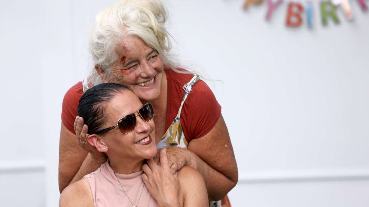 Renee Shaw, Showers of Hope founder, hugs Sharon Kuslaka as they pose for a photo at the Showers of Hope trailer at Liberty Park in Salt Lake City on Wednesday. Showers of Hope is celebrating one year of service.