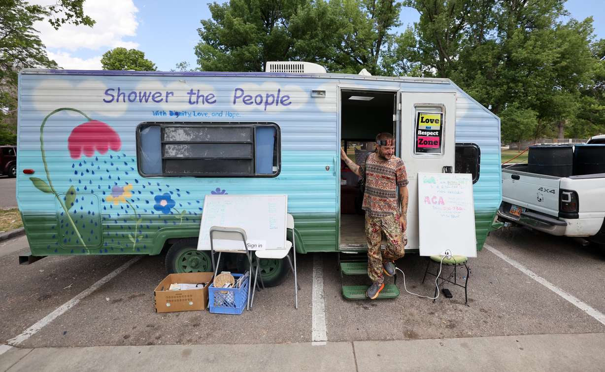 Branden “Bumblebee” Gambino, Showers of Hope manager, steps out of the Showers of Hope trailer at Liberty Park in Salt Lake City on Wednesday. Showers of Hope is celebrating one year of service.
