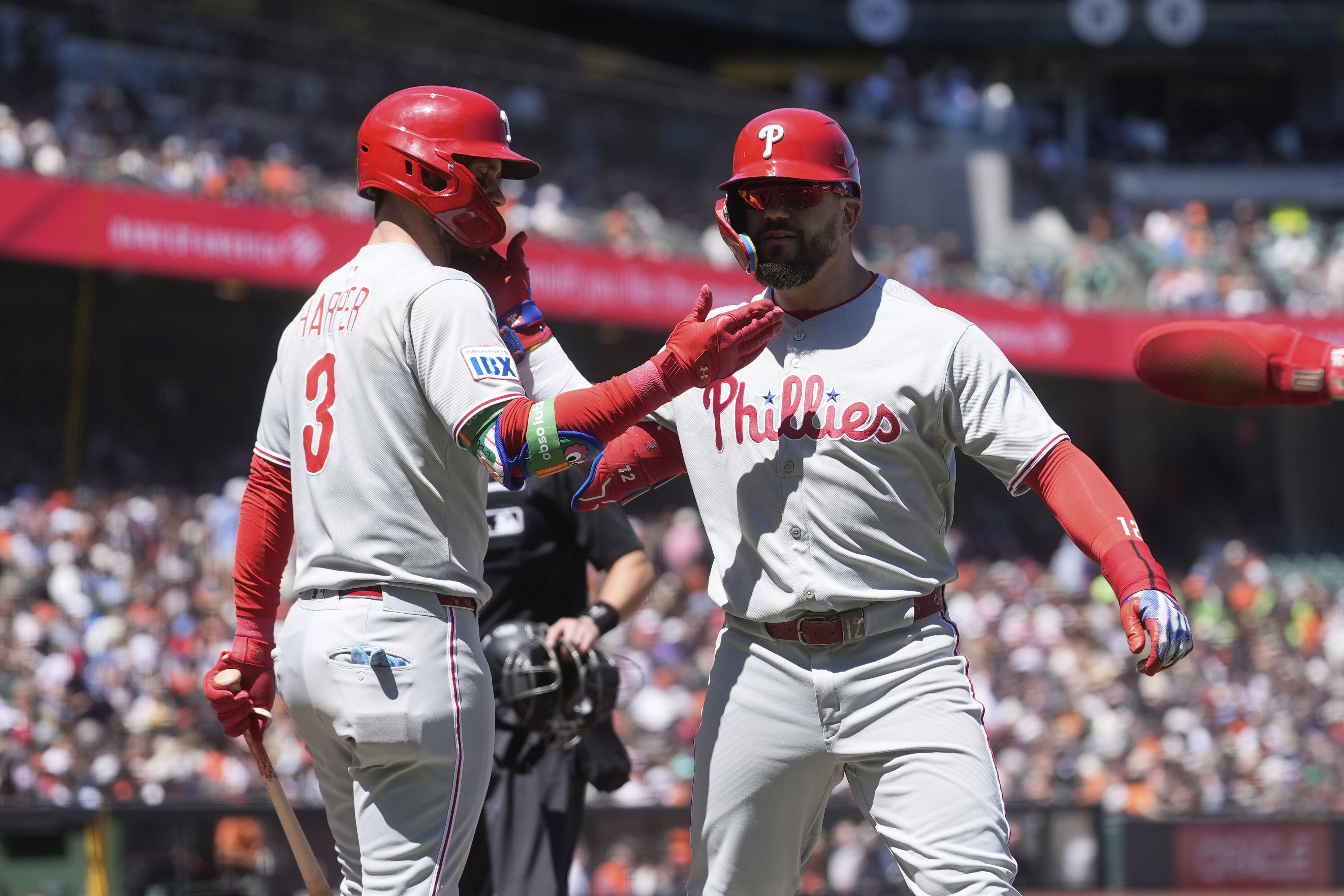 Philadelphia Phillies' Kyle Schwarber, right, is congratulated by Bryce Harper after hitting a three-run home run that also scored J.T. Realmuto and Trea Turner during the eighth inning of a baseball game against the San Francisco Giants in San Francisco, Wednesday, July 9, 2025.