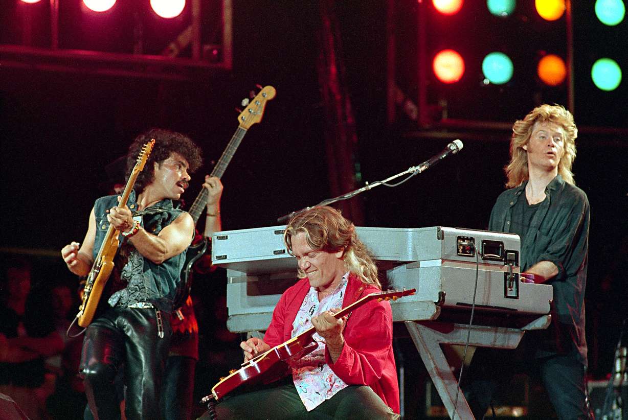 John Oates, from left, G.E.Smith and Daryl Hall perform at JFK Stadium in Philadelphia for the Live Aid famine relief concert on July 13, 1985.