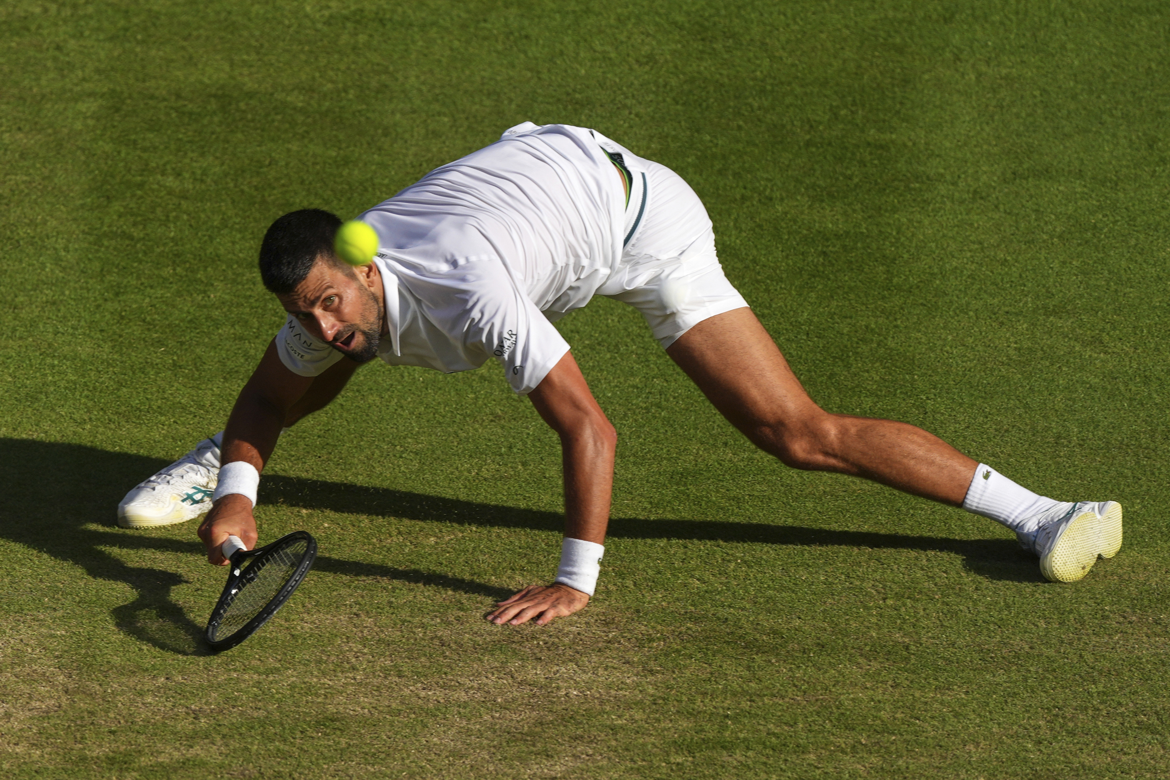 Serbia's Novak Djokovic returns to Italy's Flavio Cobolli during a quarterfinal men's singles match at the Wimbledon Tennis Championships in London, Wednesday, July 9, 2025.