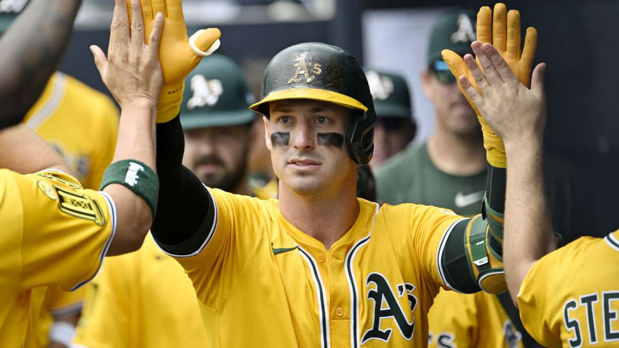 Athletics' Brent Rooker is greeted in the dugout after hitting a solo home run in the first inning of a baseball game against the Tampa Bay Rays, Wednesday, July 2, 2025, in Tampa, Fla.