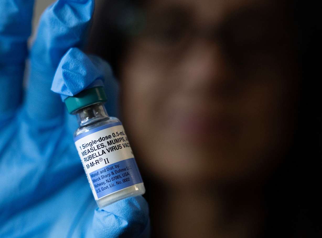 Jody deJonge, R.N., holds a vial of the measles, mumps and rubella vaccination at the Salt Lake Public Health Center on Wednesday. CDC data shows 88.8% of children have the vaccine, lower than 98.3% before the 2005-06 school year.