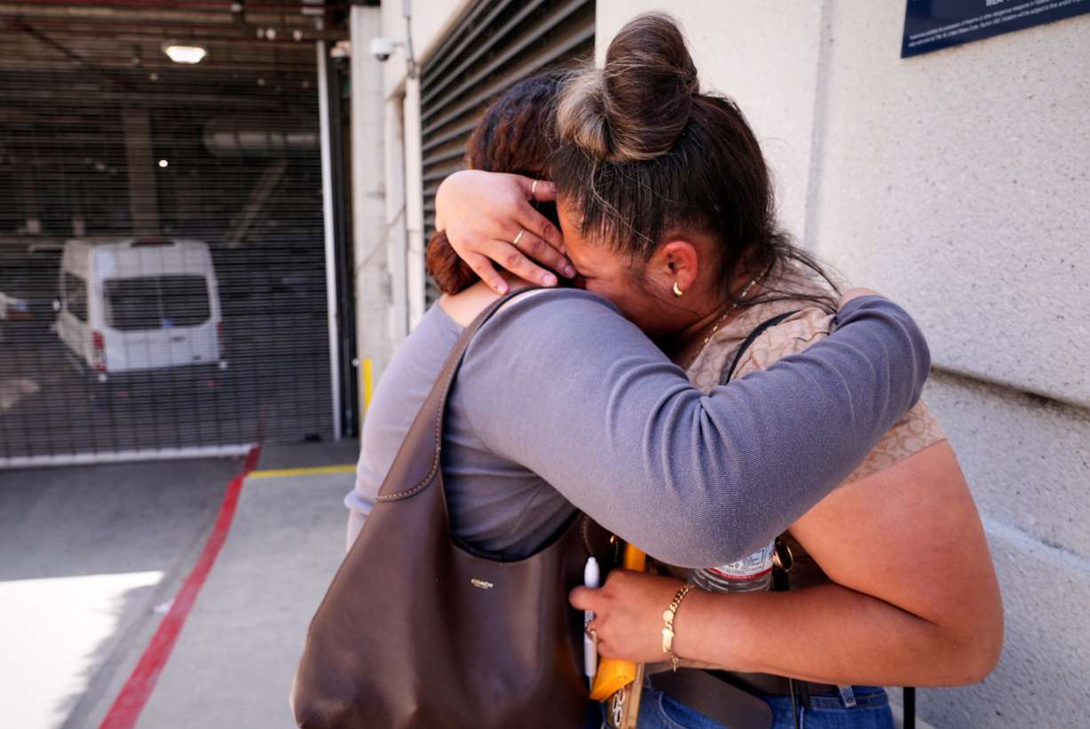 Jasmin Camacho Picazo is hugged by her niece Jenny Cardenas outside the Metropolitan Detention Center, where Picazo's husband Felipe Picazo is detained, on June 23 in Los Angeles. The Trump administration has amped up deportation efforts in California in recent weeks.