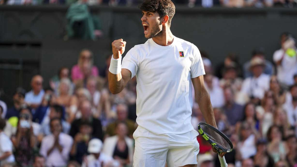 Spain's Carlos Alcaraz celebrates after beating Britain's Cameron Norrie during a quarterfinal men's singles match at the Wimbledon Tennis Championships in London, Tuesday, July 8, 2025.