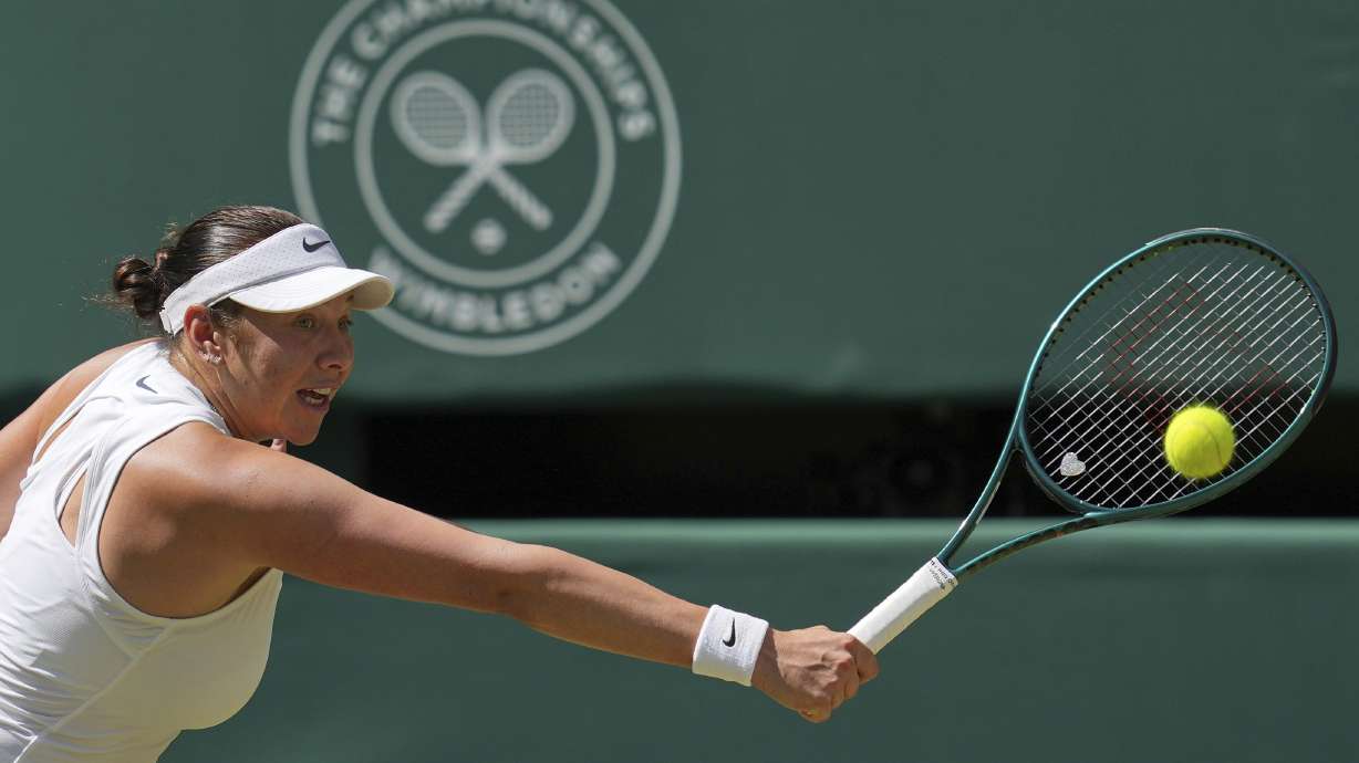 Amanda Anisimova of the U.S. returns to Aryna Sabalenka of Belarus during a women's singles semifinal match at the Wimbledon Tennis Championships in London, Thursday, July 10, 2025.
