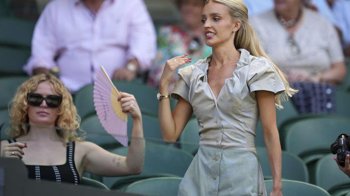 Morgan Riddle the girlfriend of Taylor Fritz of the U.S. arrives to take her seat before her boyfriend plays Spain's Carlos Alcaraz in a men's singles semifinal at the Wimbledon Tennis Championships in London, Friday, July 11, 2025.