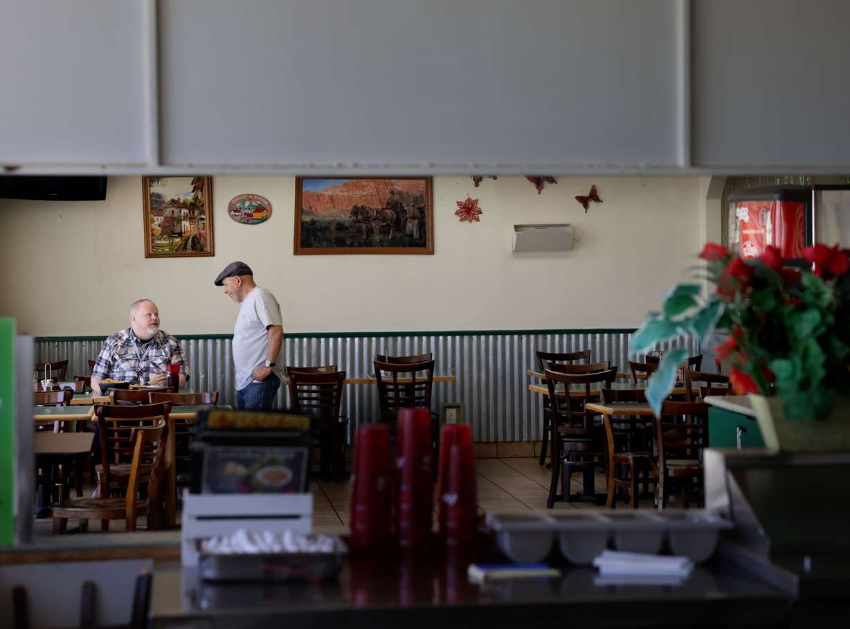 El Asadero owner Margarito Parra chats with customer Josh Ridderhoff at the Salt Lake City restaurant on Thursday. El Asadero, which opened in 2009, will close after its last day of business on July 31. Ridderhoff, who works nearby, has been coming to the restaurant for lunch a few times a week for 13 years.