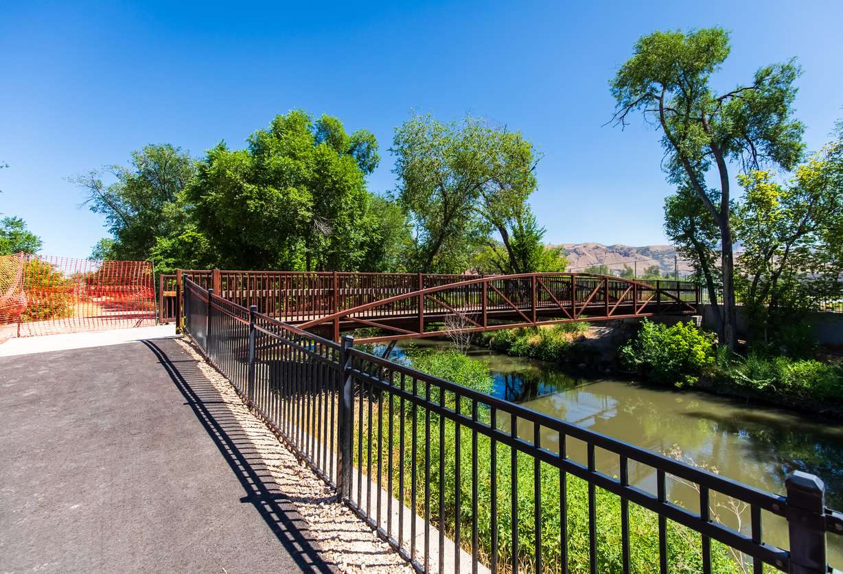 A new section of the Jordan River Parkway trail by a bridge near 600 North in Salt Lake City is pictured on Friday. The bridge was installed in 2022 but now links to a section of the trail rerouted to west of the Jordan River.