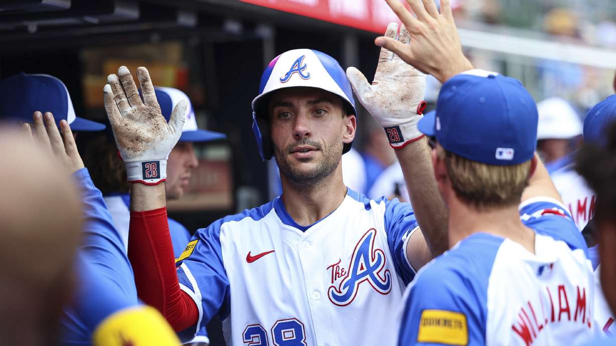 Atlanta Braves' Matt Olson (28) high-fives teammates in the dugout after hitting a solo home run in the third inning of a baseball game against the Baltimore Orioles, Saturday, July 5, 2025, in Atlanta.
