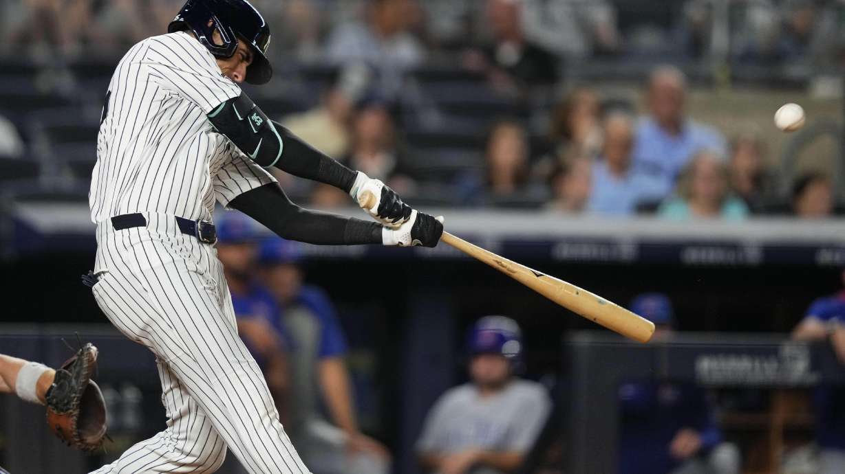 New York Yankees' Cody Bellinger hits a home run during the eighth inning of a baseball game against the Chicago Cubs, Friday, July 11, 2025, in New York.