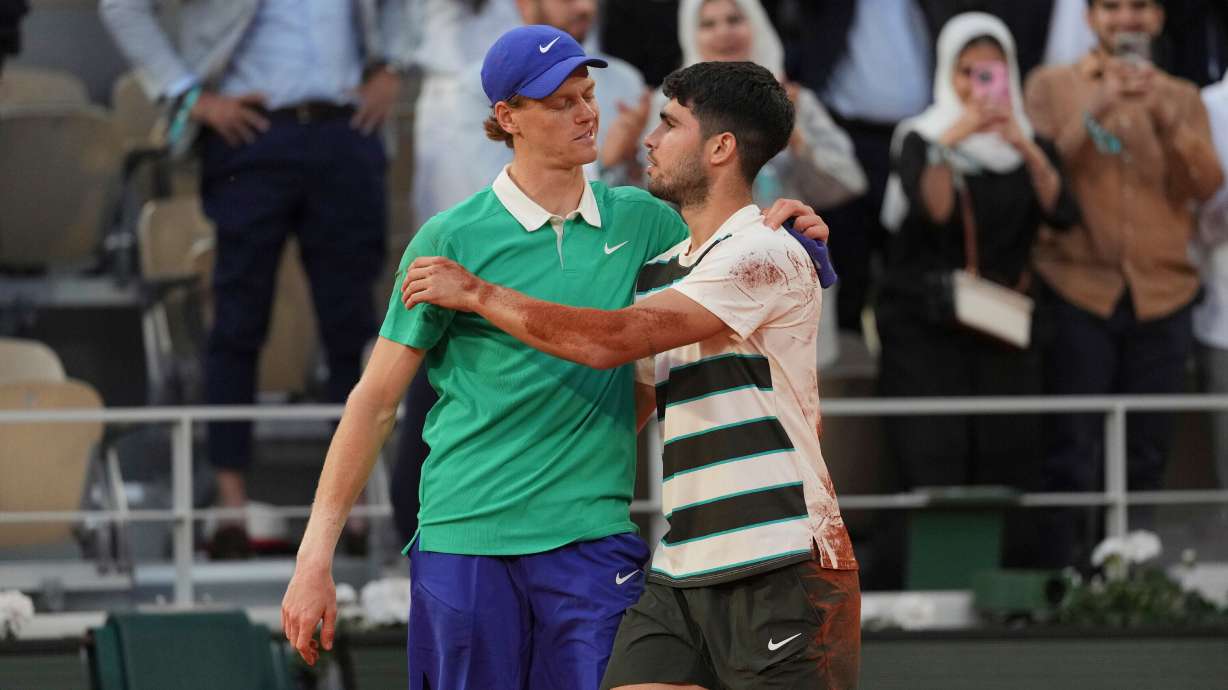 FILE - Winner Spain's Carlos Alcaraz, right, and Italy's Jannik Sinner hug after the final match of the French Open tennis tournament at the Roland-Garros stadium in Paris, June 8, 2025.