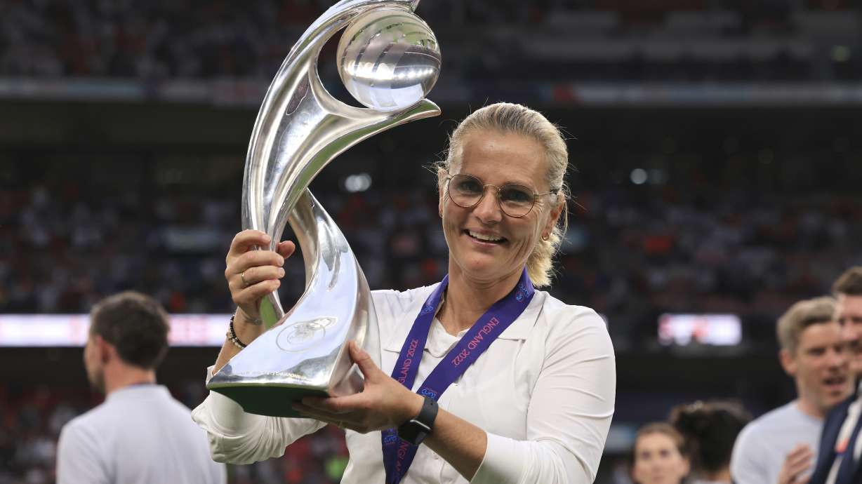 FILE - England's manager Sarina Wiegman poses with the trophy after the Women's Euro 2022 final soccer match between England and Germany at Wembley stadium in London, Sunday, July 31, 2022.