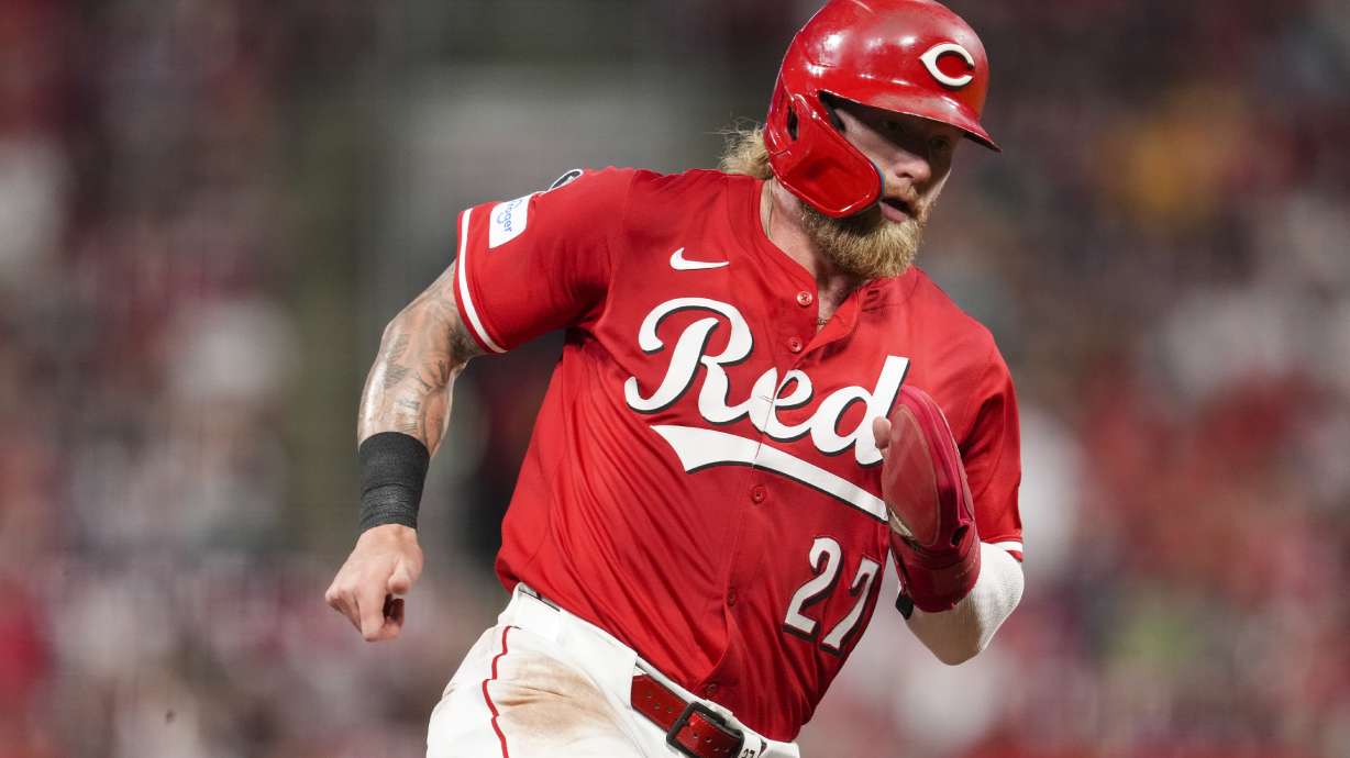 Cincinnati Reds' Jake Fraley rounds third base and scores on a double hit by TJ Friedl during the sixth inning of a baseball game against the Minnesota Twins, Tuesday, June 17, 2025, in Cincinnati.