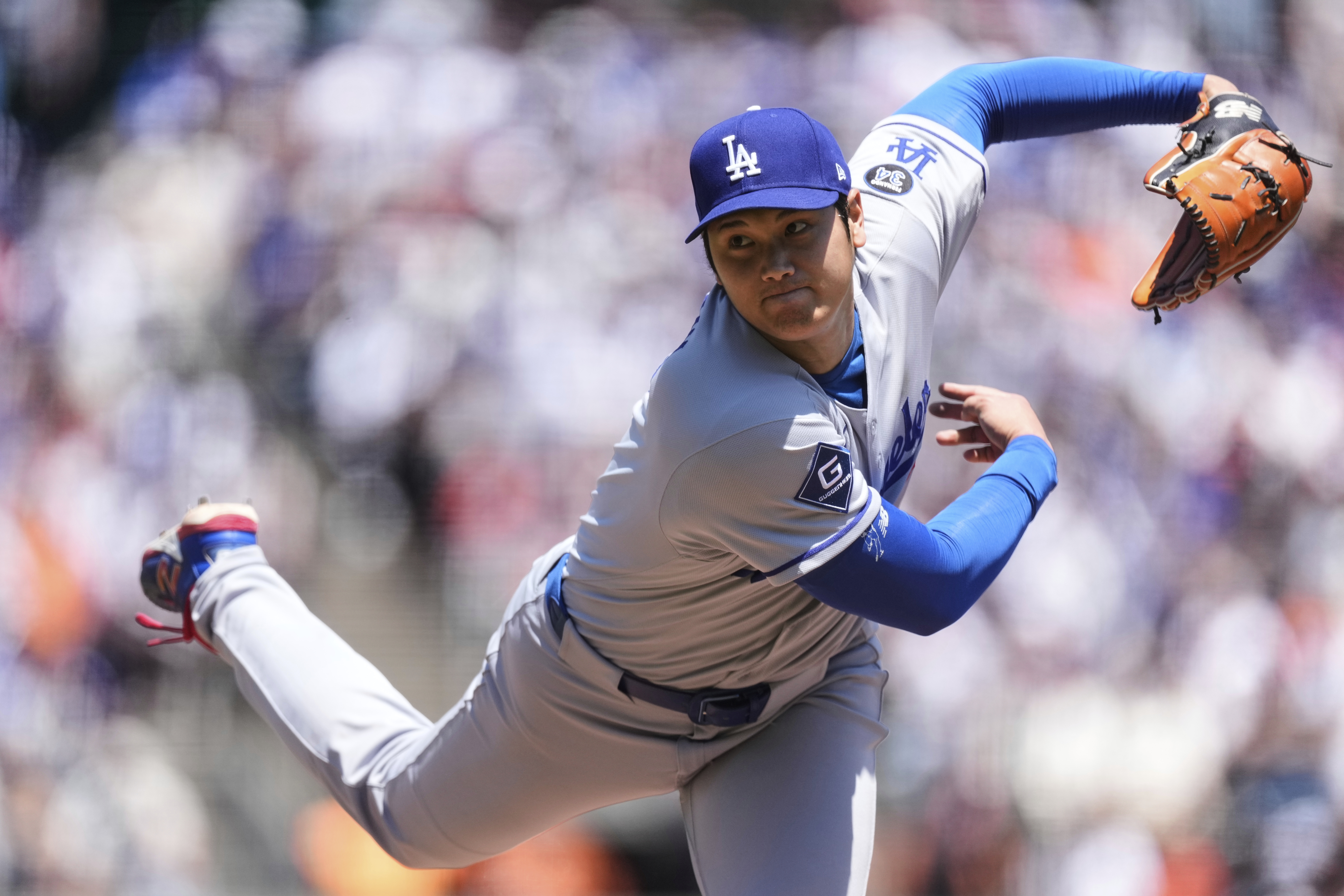 Los Angeles Dodgers' Shohei Ohtani follows through on his pitch to a San Francisco Giants batter during the third inning of a baseball game Saturday, July 12, 2025, in San Francisco.