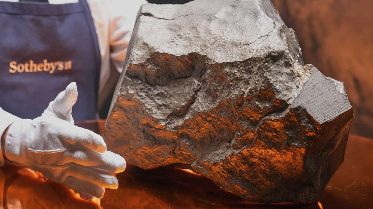A Martian meteorite, weighing 54.388 lbs., said to be the largest piece of Mars on Earth, estimated at $2-4 million, is displayed at Sotheby's, in New York, Wednesday, part of their Geek Week auction, planned for July 16.