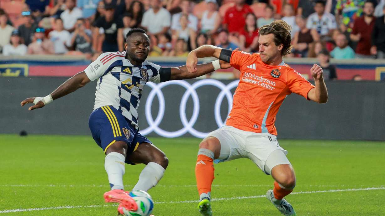 Real Salt Lake forward Willy Agada (9) dibbles against Houston Dynamo defender Ethan Bartlow (4) during the second half of the game at America First Field in Sandy on Saturday, July 12, 2025.