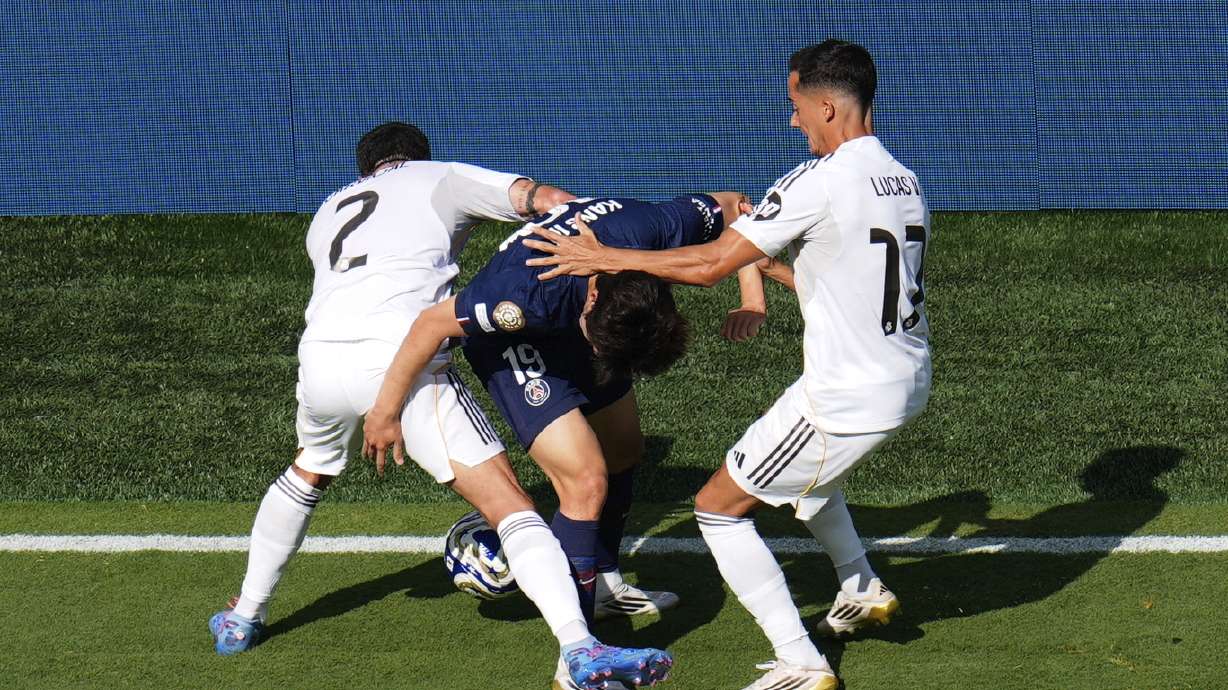 Real Madrid's Dani Carvajal (2) and Lucas Vazquez (17) compete against Paris Saint-Germain's Lee Kang-in (19) for control of the ball during the Club World Cup semifinal soccer match between PSG and Real Madrid in East Rutherford, N.J., Wednesday, July 9, 2025.