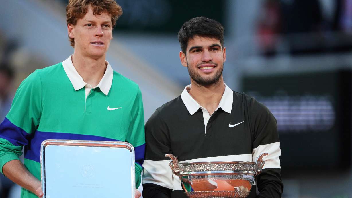 FILE - Winner Spain's Carlos Alcaraz, right, and second placed Italy's Jannik Sinner pose with trophies after the final match of the French Open tennis tournament at the Roland-Garros stadium in Paris, Sunday, June 8, 2025.