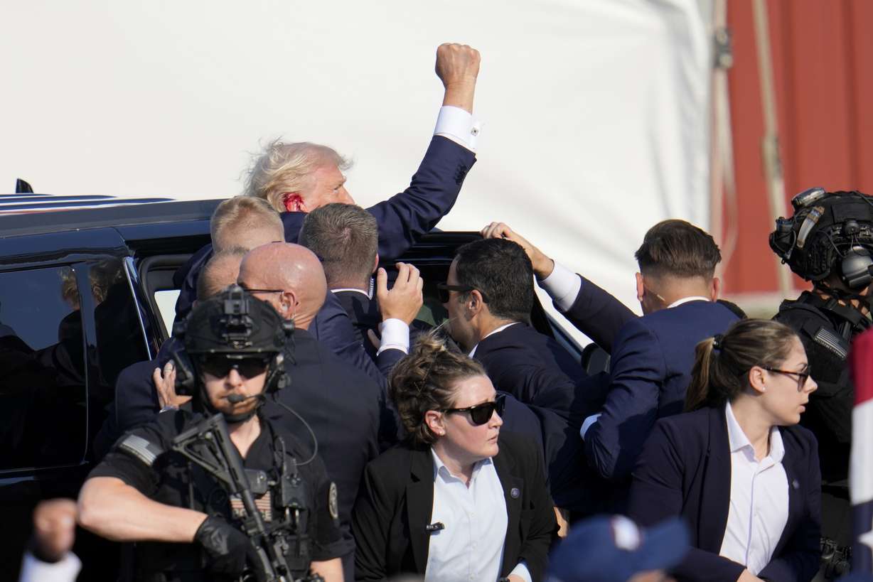 Republican presidential candidate former President Donald Trump is escorted to a motorcade following an attempted assassination at a campaign event in Butler, Pa., July 13, 2024.