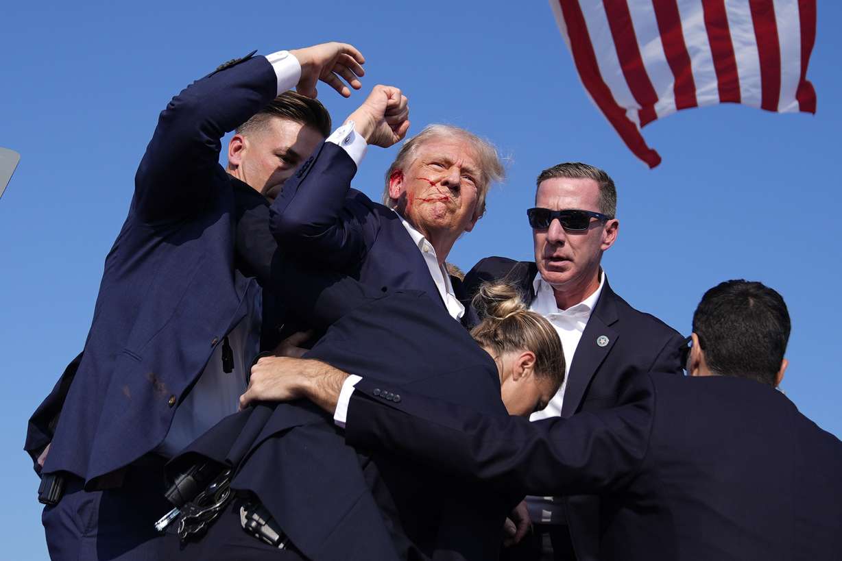 Republican presidential candidate former President Donald Trump is surrounded by U.S. Secret Service agents at a campaign rally, July 13, 2024, in Butler, Pa.