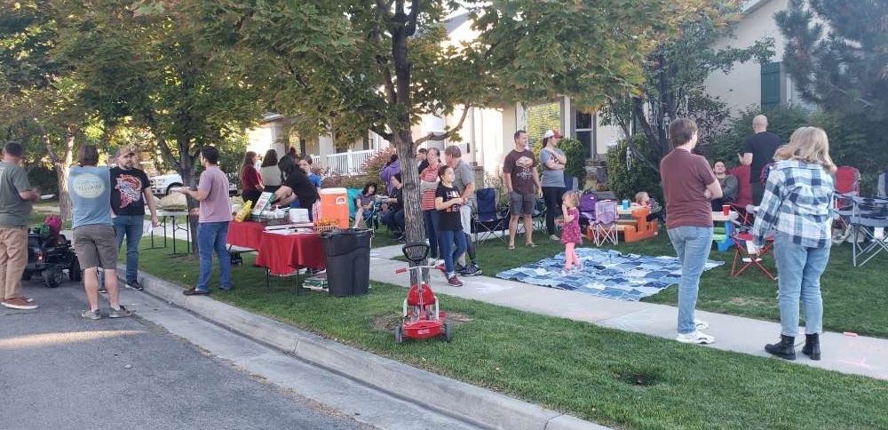 Neighbors attend a block party in Tooele. City administrators are encouraging residents to build more community connections by hosting similar events — they even agree to foot the bill.