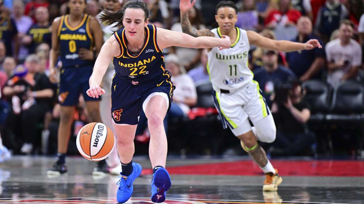 Indiana Fever's Caitlin Clark goes for a loose ball during the first half of a WNBA basketball game against the Dallas Wings, Sunday, July 13, 2025, in Indianapolis.