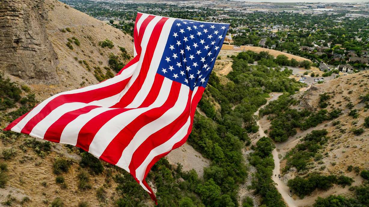 The “Follow The Flag” flag waves in the wind as it is displayed in Grove Creek Canyon in Pleasant Grove on July 9. Every summer at the entrance to Grove Creek Canyon, Kyle Fox flies the world's biggest American flag.
