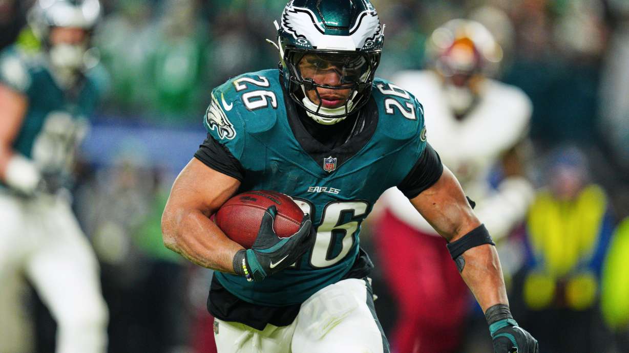 FILE - Philadelphia Eagles running back Saquon Barkley (26) rushes for a touchdown against the Washington Commanders during the second half of the NFC Championship NFL football game, Sunday, Jan. 26, 2025, in Philadelphia.