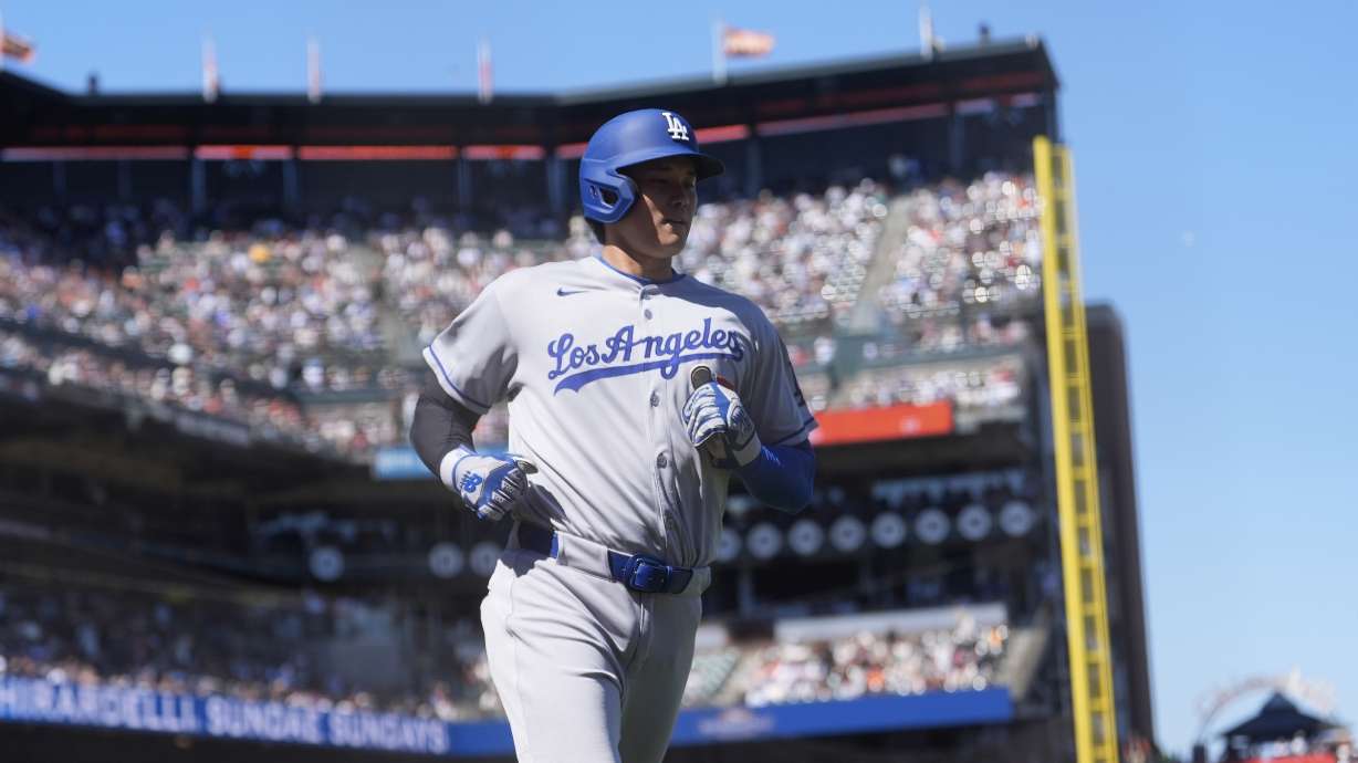 Los Angeles Dodgers' Shohei Ohtani scores against the San Francisco Giants during the 11th inning of a baseball game in San Francisco, Sunday, July 13, 2025.