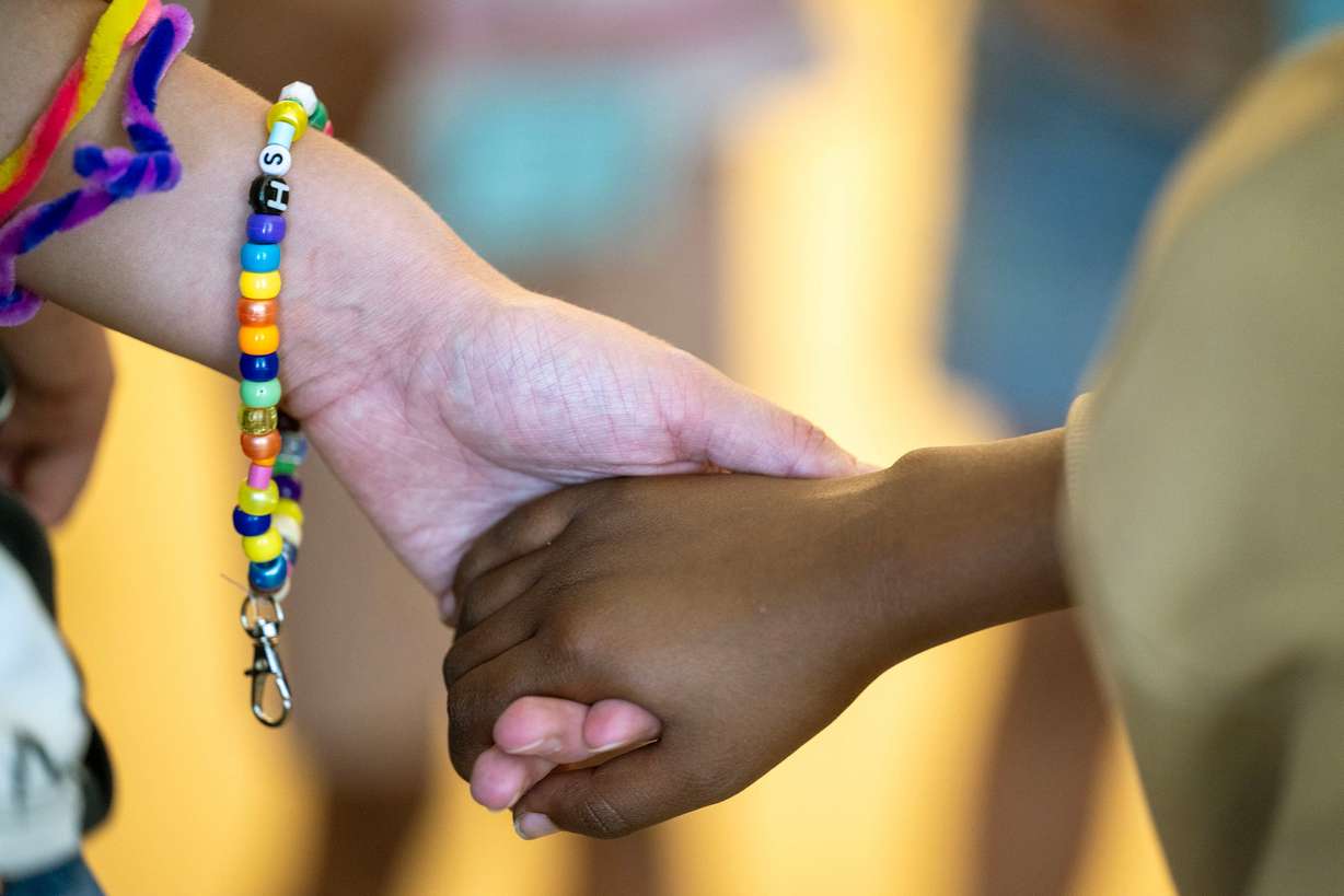 A group of girls and counselors circle up at the end of their time together as they take part in summer activities assisted by counselors at Central Park Community Center in South Salt Lake City on Monday.