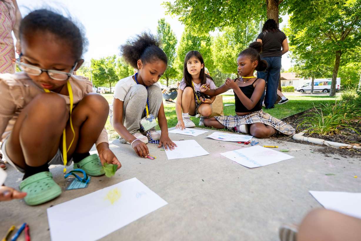 From left, Selihom, Eltana, Maddie and Soleina use leaves and crayons to make art as they and other kids take part in summer activities assisted by counselors at Central Park Community Center in South Salt Lake City on Monday.