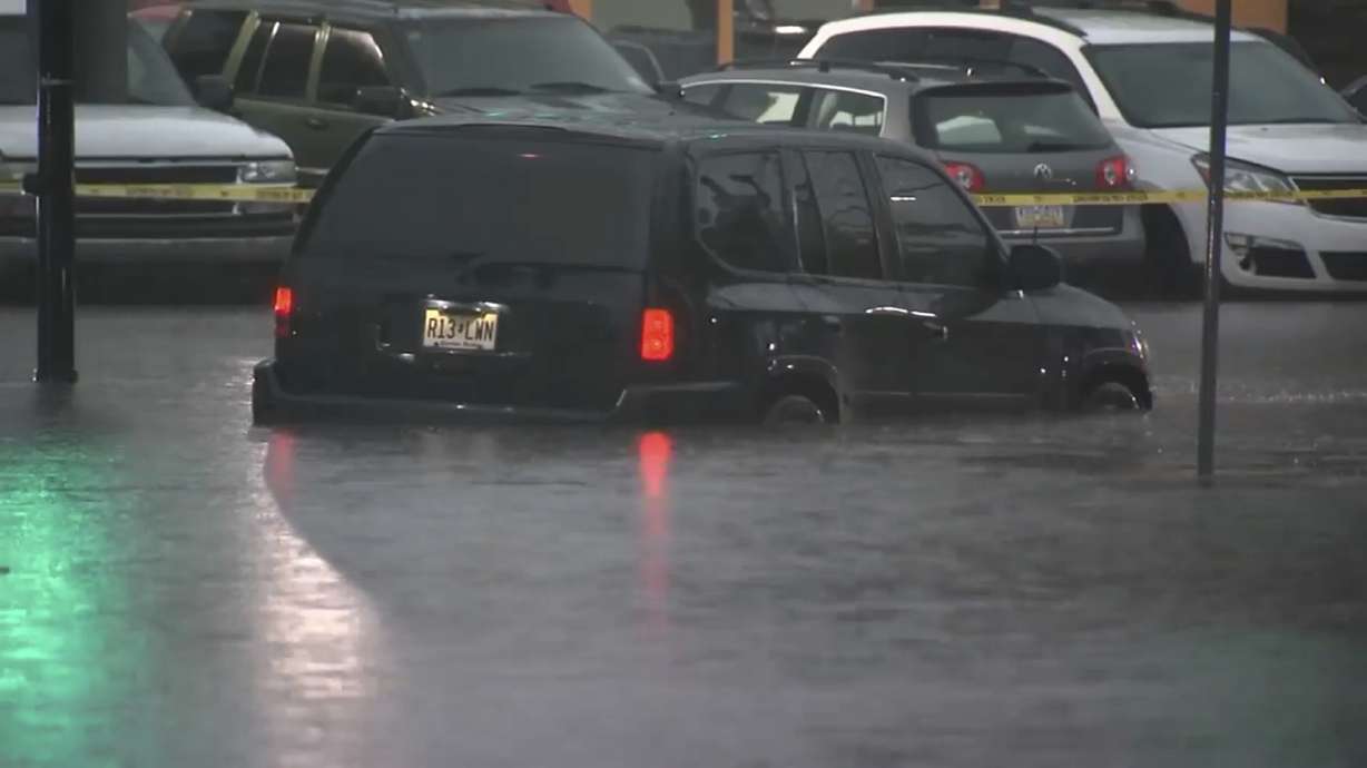 Cars are submerged in floodwaters in Rahway, NJ., on Monday. Authorities say two people were killed after their vehicle was swept up in floodwaters during a storm that moved across the U.S. Northeast overnight.