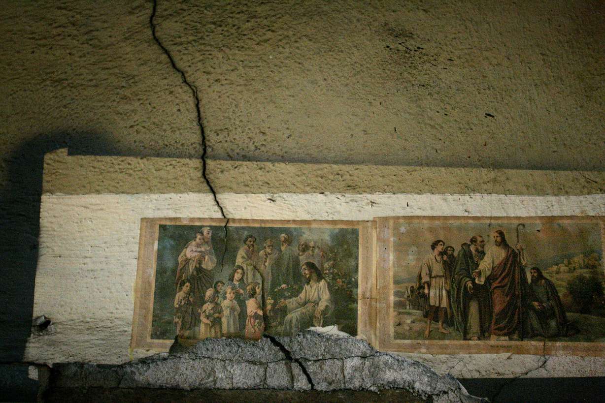 A crack runs through old religious illustrations in the Fisher Mansion from the time when nuns lived in the house on Feb. 8, 2008.