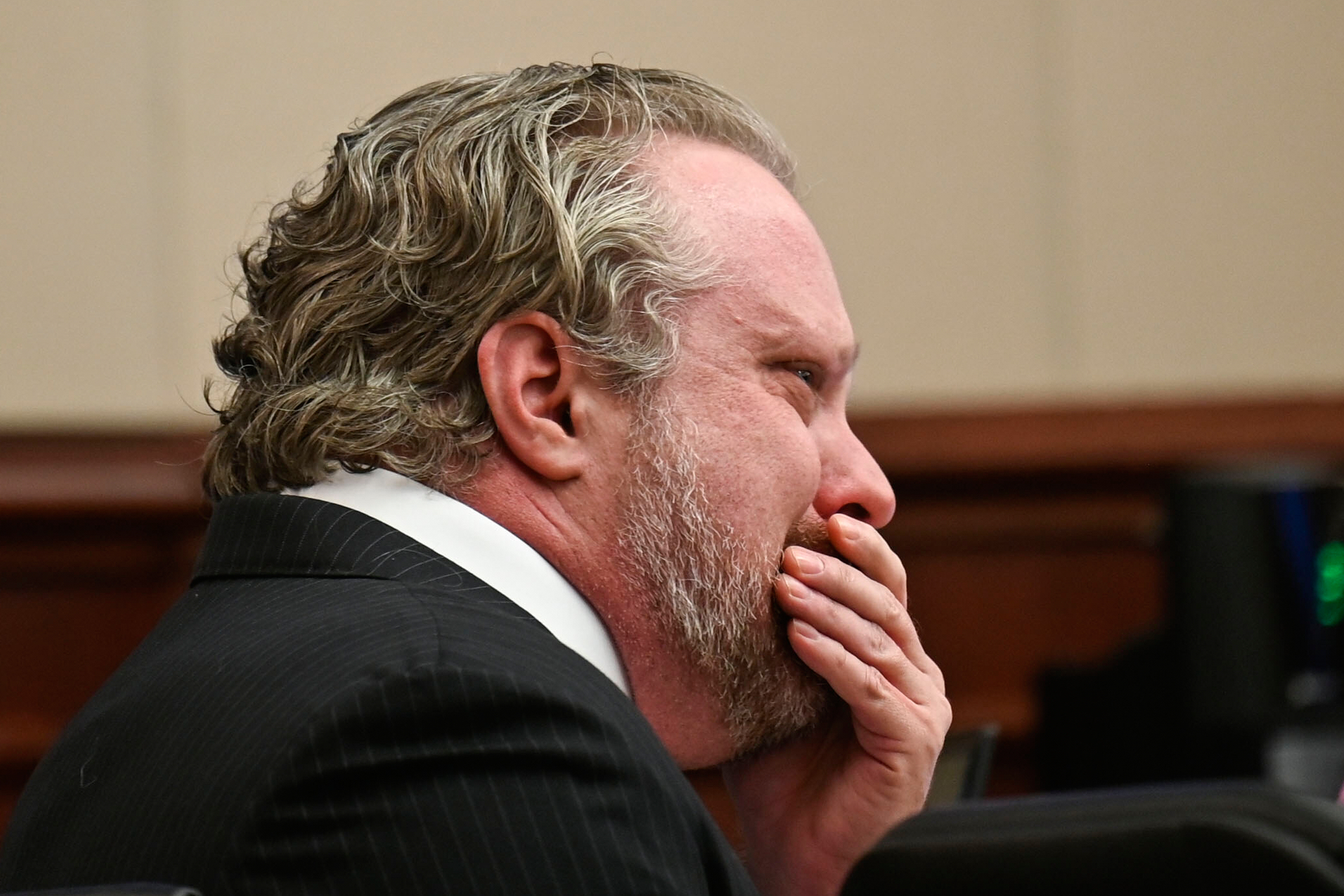 James Craig wipes his face during opening arguments in his murder trial at the Arapahoe District Court Tuesday in Centennial, Colo. He is accused of killing his wife with poison.