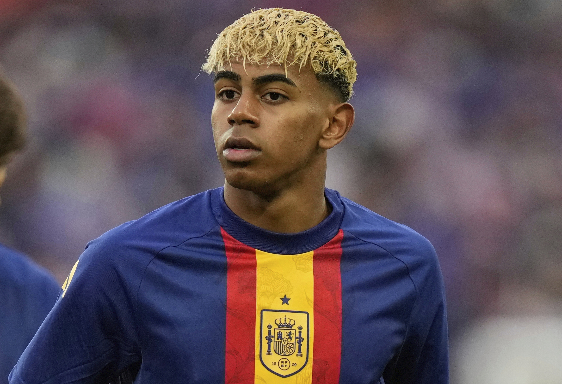 FILE - Spain's Lamine Yamal, center, warms up for the Nations League semifinal soccer match between Spain and France in Stuttgart, Germany, June 5, 2025.