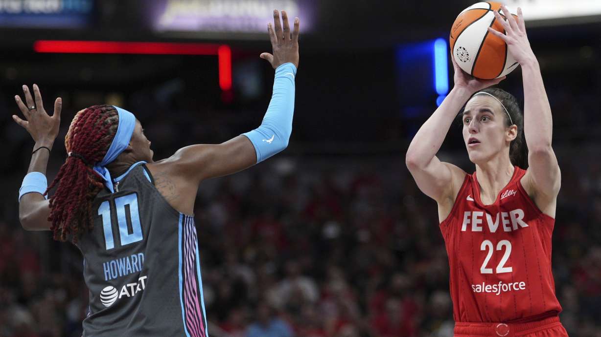 Indiana Fever's Caitlin Clark (22) shoots over Atlanta Dream's Rhyne Howard (10) during the second half of a WNBA basketball game, Friday, July 11, 2025, in Indianapolis.