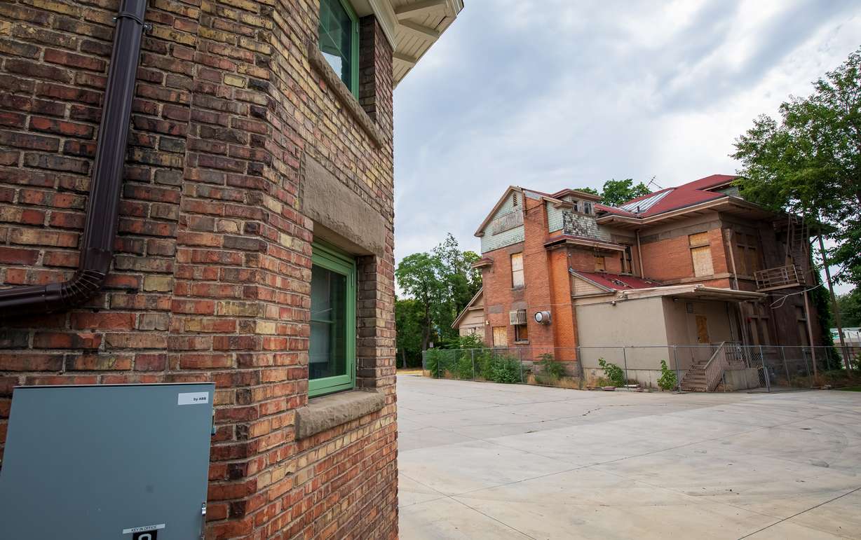 The Fisher Mansion in Salt Lake City is pictured on Tuesday next to its carriage house. The carriage house was recently renovated and Salt Lake City is exploring the same for the historic home.