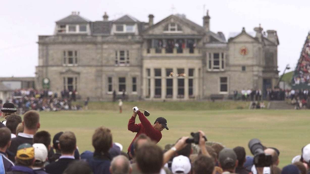 FILE -Tiger Woods of the United States tees off from the 18th towards the club house of the Royal and Ancient during the British Open golf championship on the Old Course at St. Andrews in Scotland, July 23, 2000.