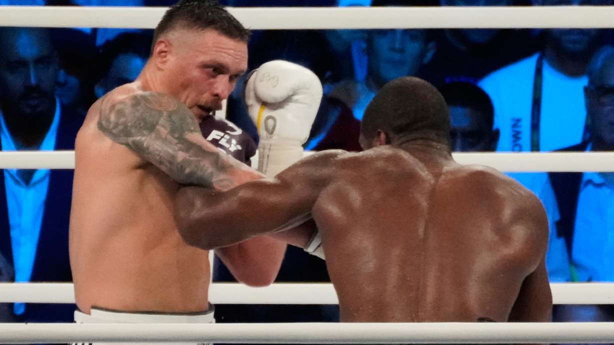 FILE - Ukraine's Oleksandr Usyk lands a blow on Britain's Daniel Dubois during their world heavyweight title fight at Tarczynski Arena in Wroclaw, Poland, Aug. 26, 2023.
