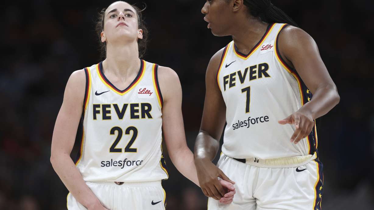 Indiana Fever's Caitlin Clark (22) reacts with a possible injury beside Aliyah Boston (7) during the second half of a WNBA basketball game against the Connecticut Sun, Tuesday, July 15, 2025, in Boston.