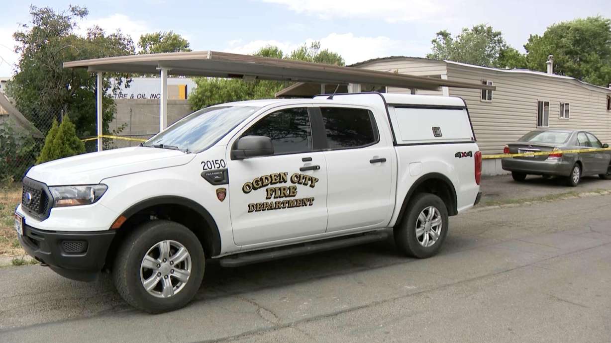 Fire officials investigate at the scene of a fatal mobile home fire at 1065 Wall Ave. in Ogden on Tuesday. Fire officials said one person died after being pulled out of the burning structure.