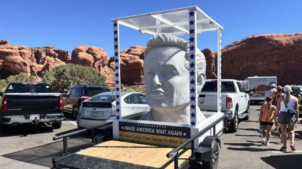 A large statue of Elon Musk's likeness was seen driving around Arches National Park on Saturday. Its caption read "Make America Wait Again: Now With Longer Lines Thanks to DOGE Cuts."